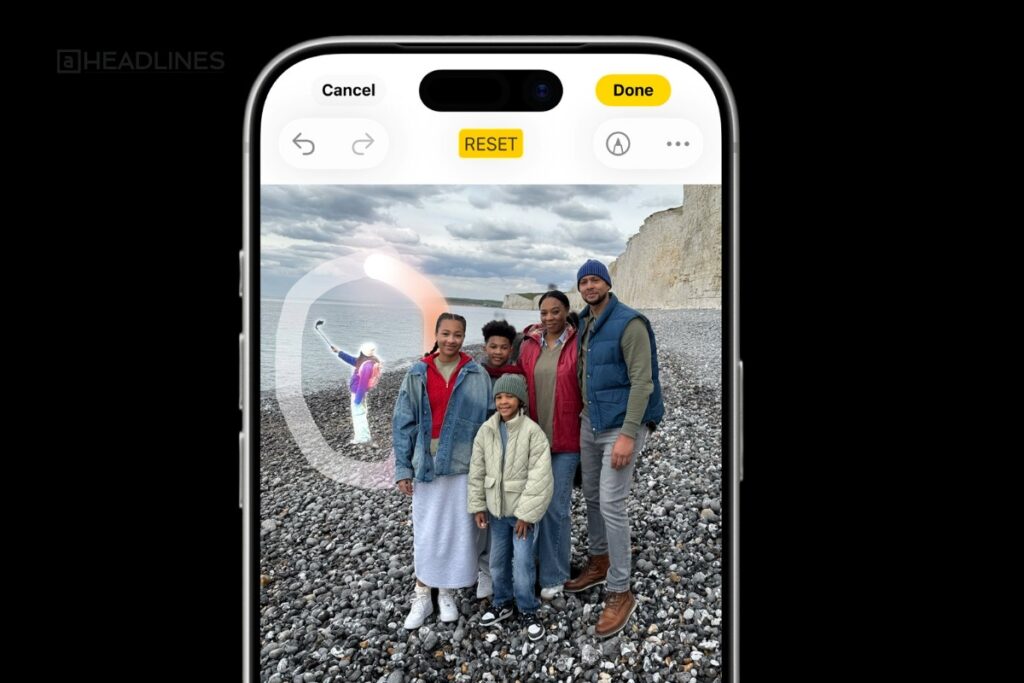 Family posing on rocky beach edited using Apple AI photo cleanup tool on iPhone screen