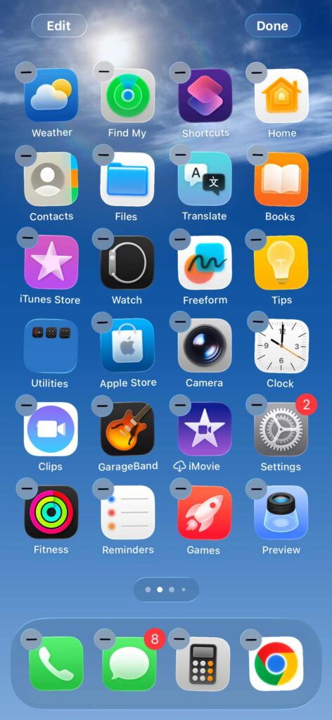 iPhone home screen with app icons in jiggle mode ready for rearranging or deleting.