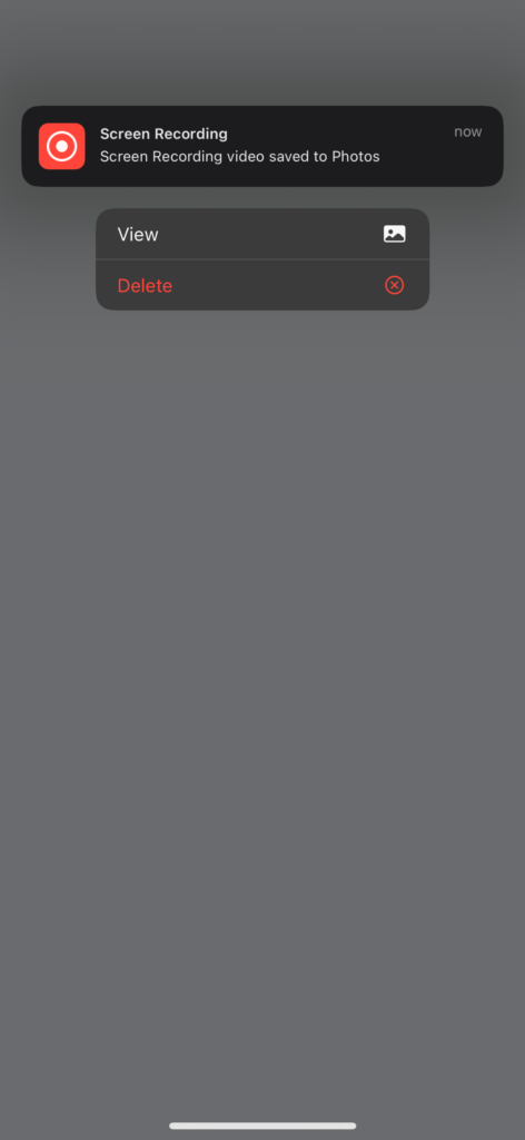 iPhone notification showing screen recording video saved to Photos with view and delete options