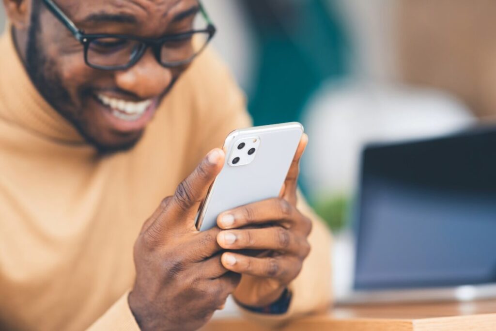 Person using apple tv remote app on iPhone to control Apple TV