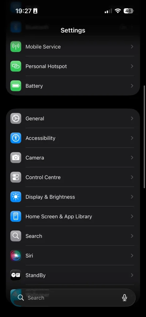 iPhone Settings page displaying the General option in dark mode