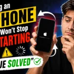 Concerned iPhone user holding a device stuck on the Apple logo while troubleshooting a restart loop issue