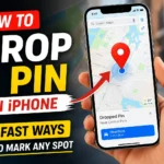 A hand holding an iPhone with Apple Maps open, showing a red location pin and the title about how to drop a pin on iPhone.