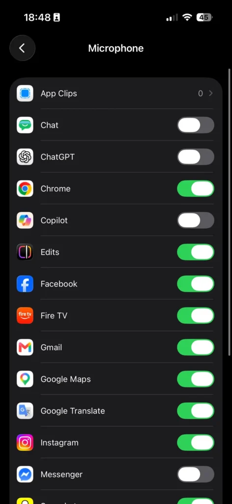 A screenshot of the iOS privacy settings showing a list of installed applications with toggle switches, demonstrating how to turn off microphone on iPhone for specific app