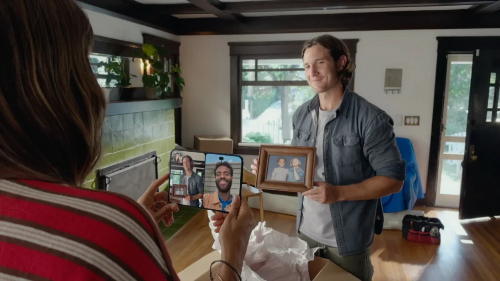Person using a foldable smartphone to capture a framed photo